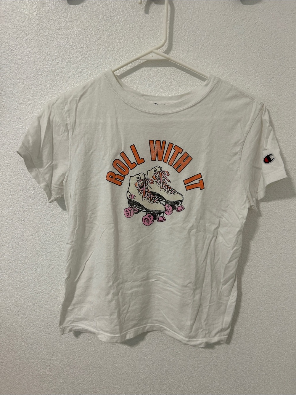 Vintage Champion White Graphic Tee with Orange Text & Pink Skate Wheels